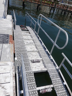 Dock ramp with assistive rails